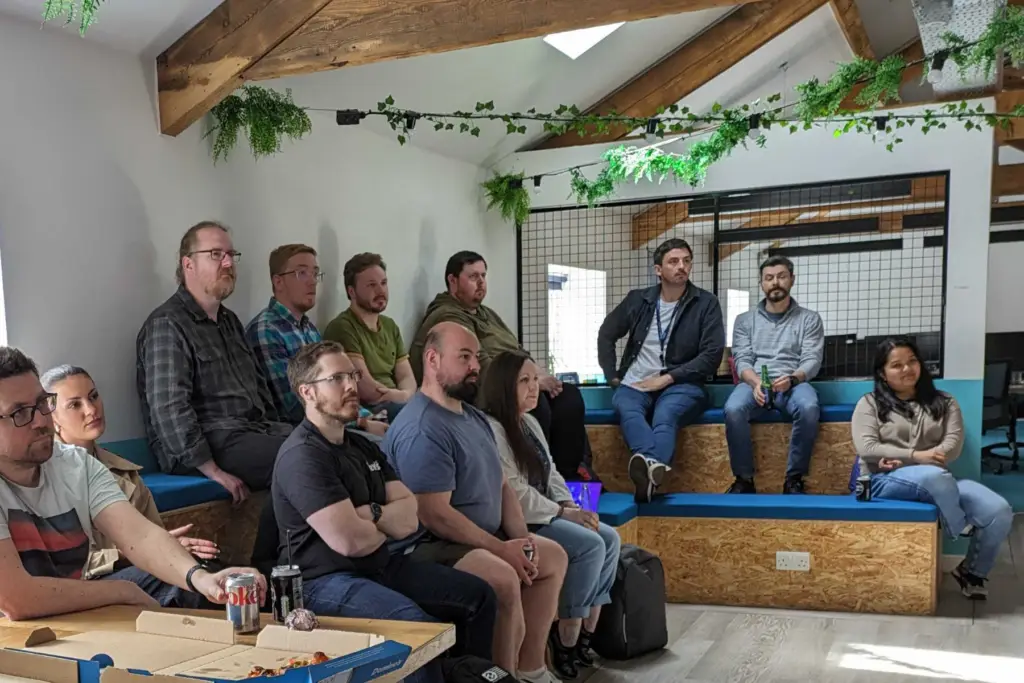 Large group of engineers meeting on tiered theatre seating at an out of office Powwow.